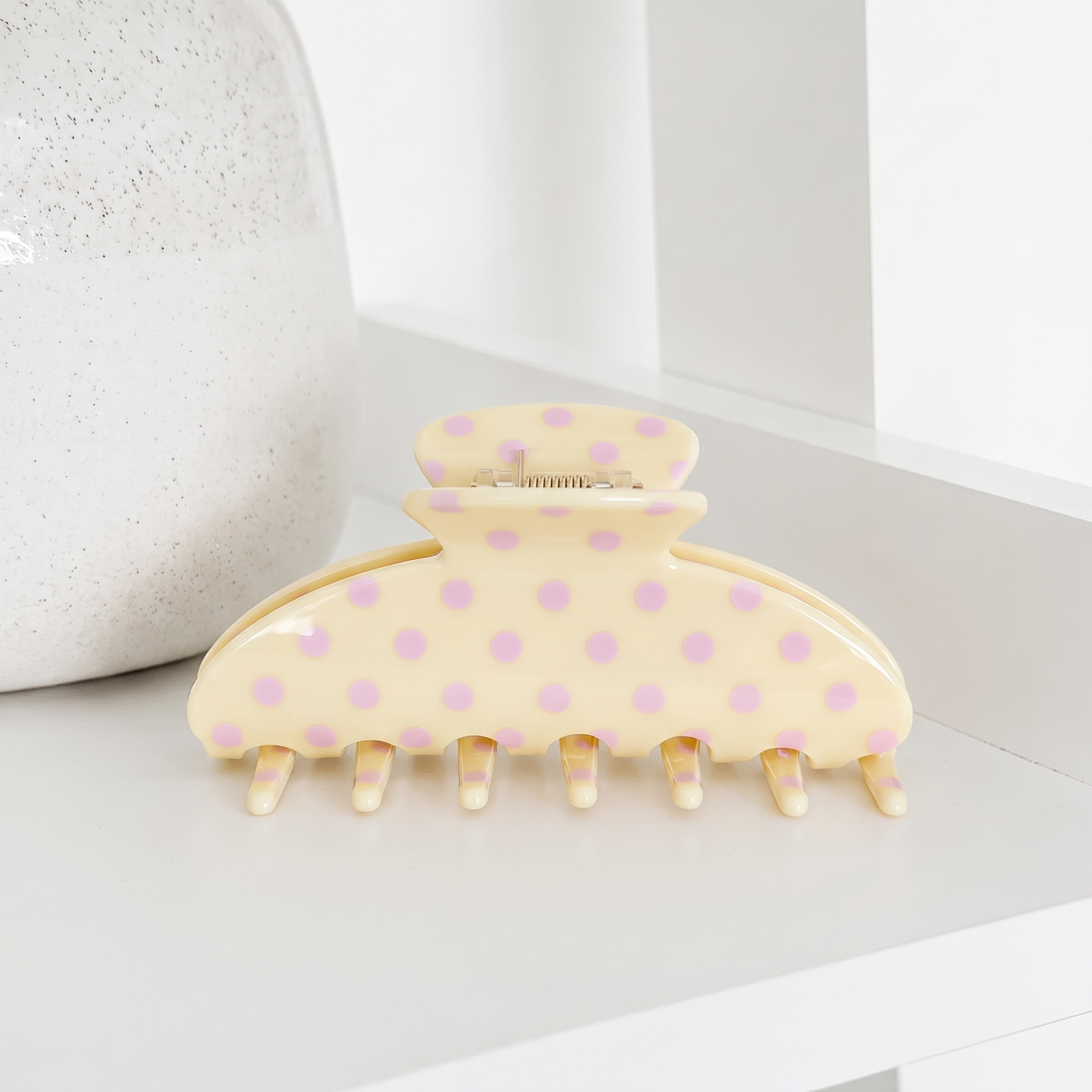 Pale yellow Claw Clip for hair with baby pink polka dots.