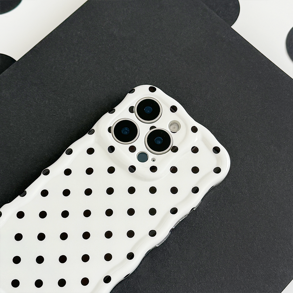 Coconut Lane wavy phone case with white polka dots on a black background.