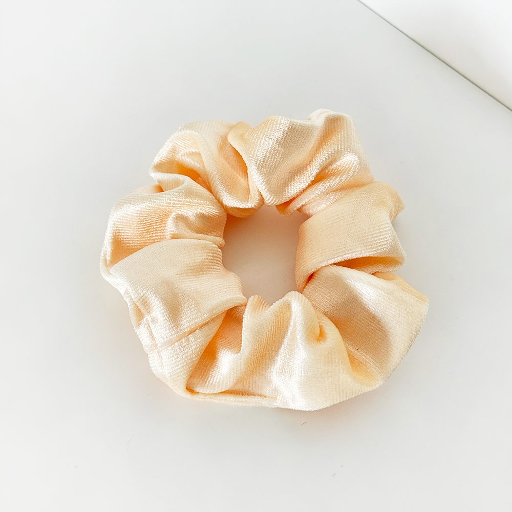 Butter yellow satin scrunchie by Coconut Lane shown on a plain white surface.