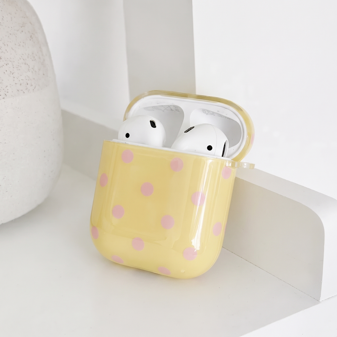 Pale yellow AirPods Case with baby pink polka dots. Showing the inside.