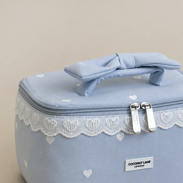 Light blue Vanity Bag with embroidered hearts. Lace trim and handle with bow.