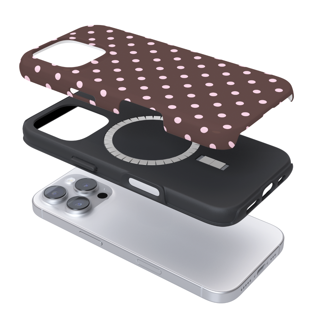 Magsafe phone case with pink polka dots on a brown background in an exploded view.