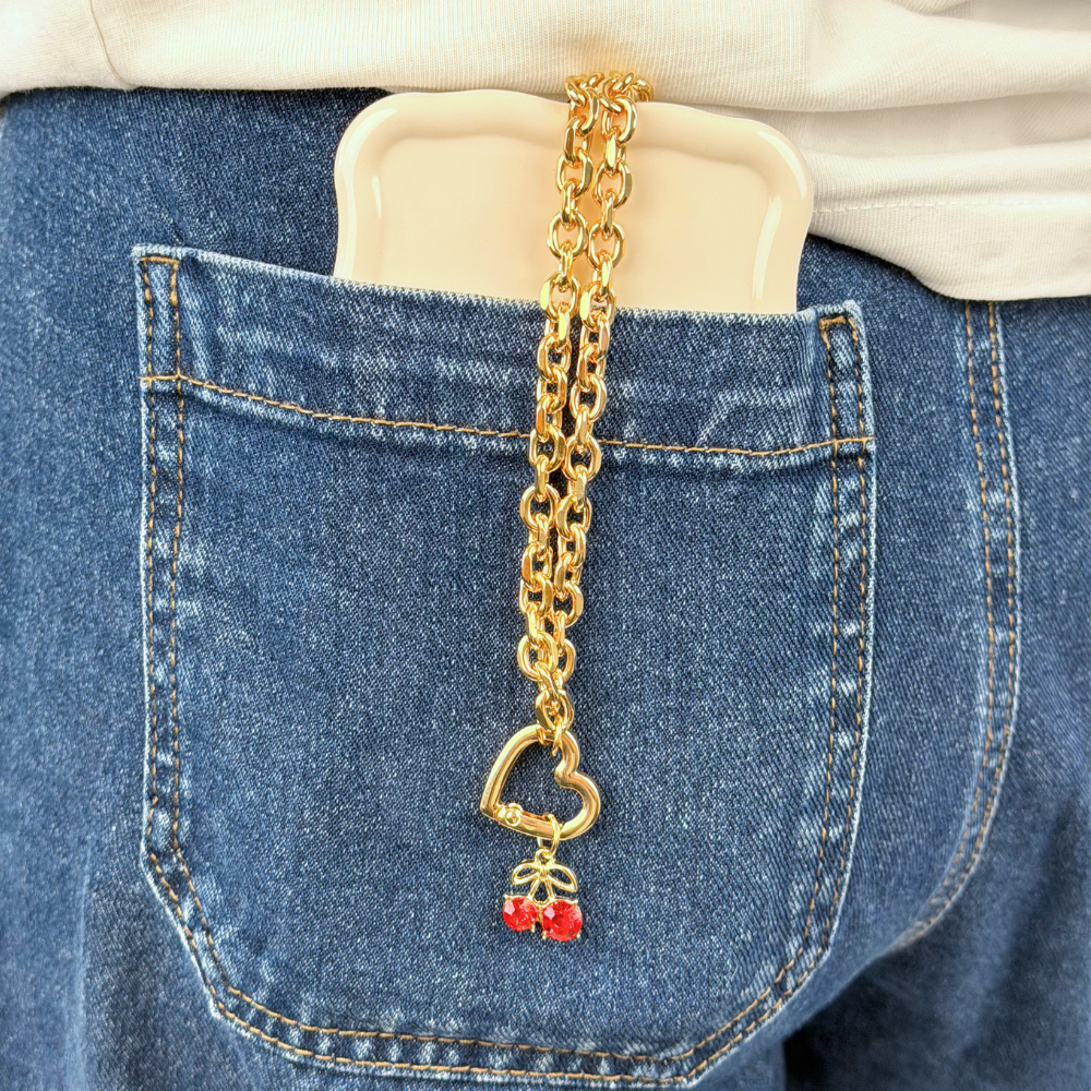 Charm Bar Heart Chain in blue denim jean pocket attached to phone case
