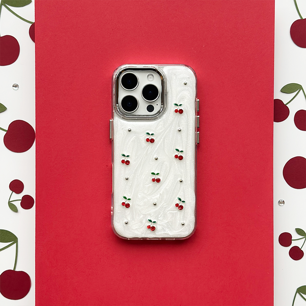 Cherry Pearl phone case with a pearl finish on a red background featuring a cherry print pattern.