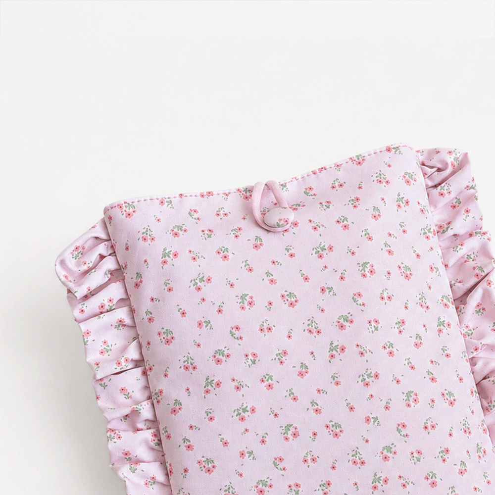 Pink floral patterned Book Sleeve with ruffled trim.