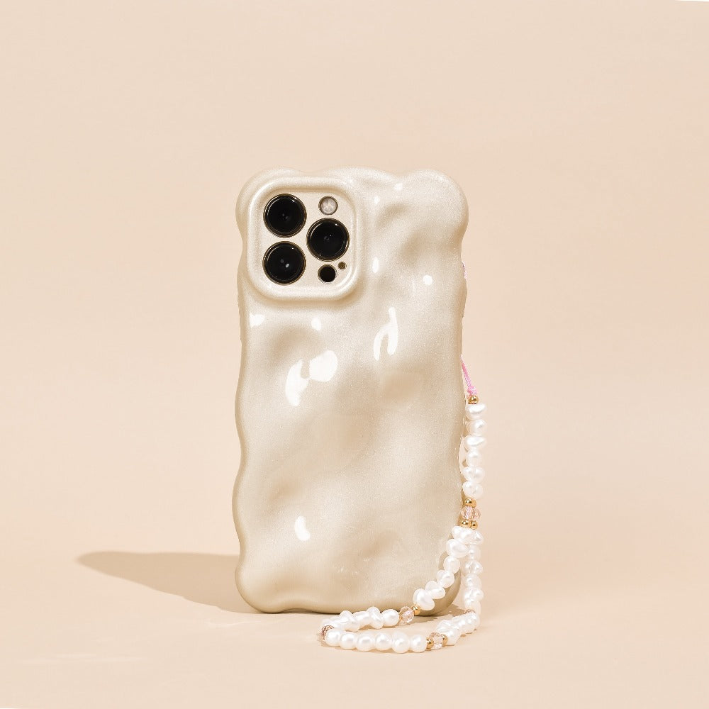 Pearl Phone Strap attached to Gold Phone Case on a beige background.