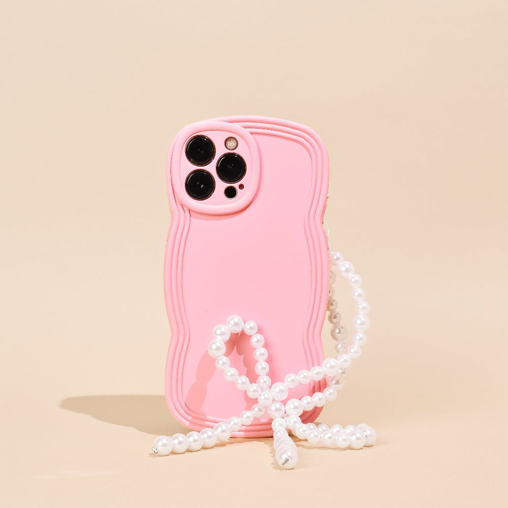 Phone Strap in a bow shape made from pearls, attached to a pink phone case.