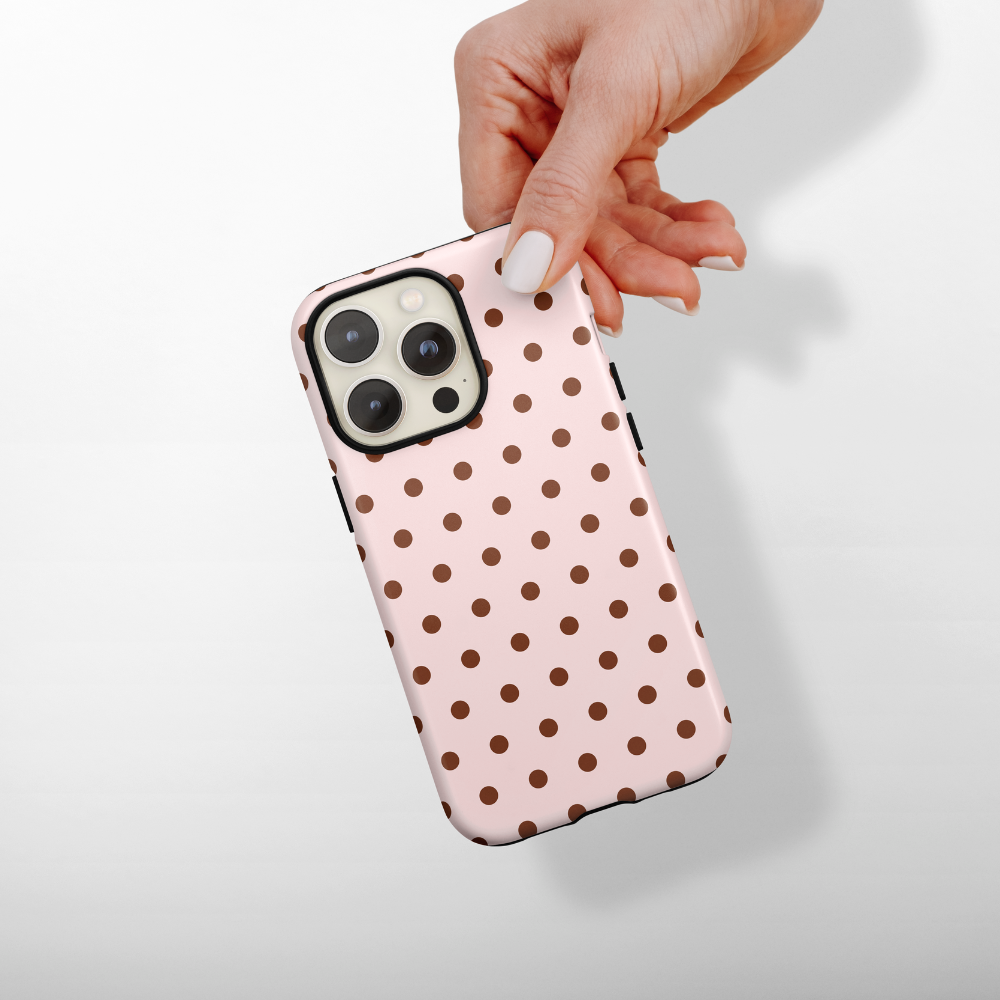 Baby pink phone case with chocolate brown polka dots.