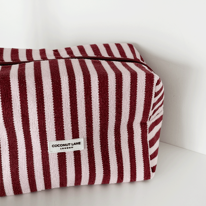 Burgundy and light pink striped Makeup Bag, silver zip and Coconut Lane logo badge.