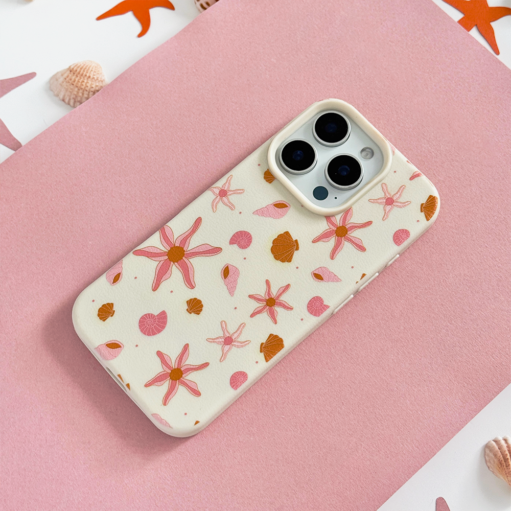 Peach-colored phone case with pink floral and seashell pattern from Coconut Lane.