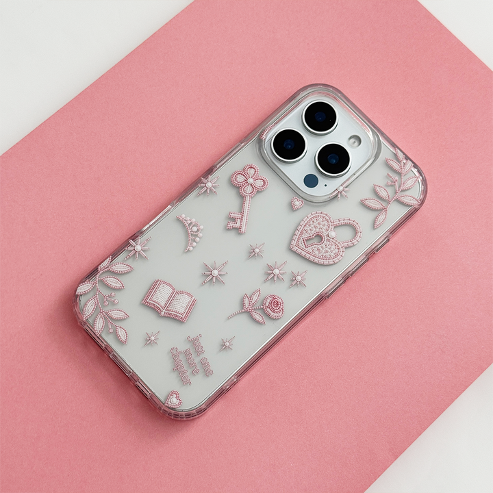 Romance Girly Clear Phone Case featuring delicate pink illustrations of a heart padlock, key, book, rose and stars, photographed diagonally on a pink background.