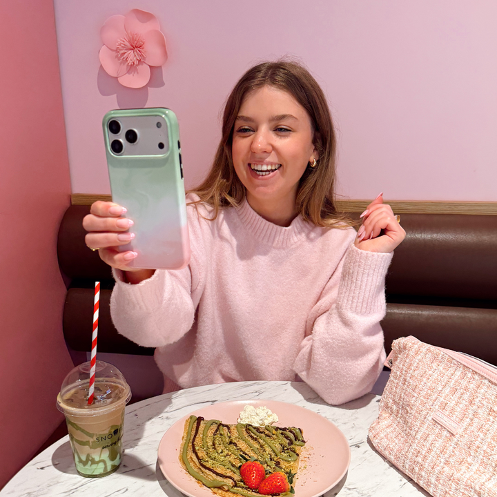 A girl taking a selfie with Strawberry Matcha Tough Phone Case