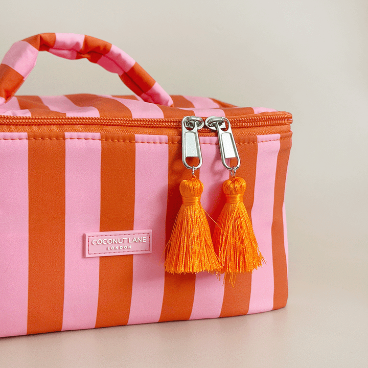 Orange and pink stripe Vanity Case, with tassels and padded handle.