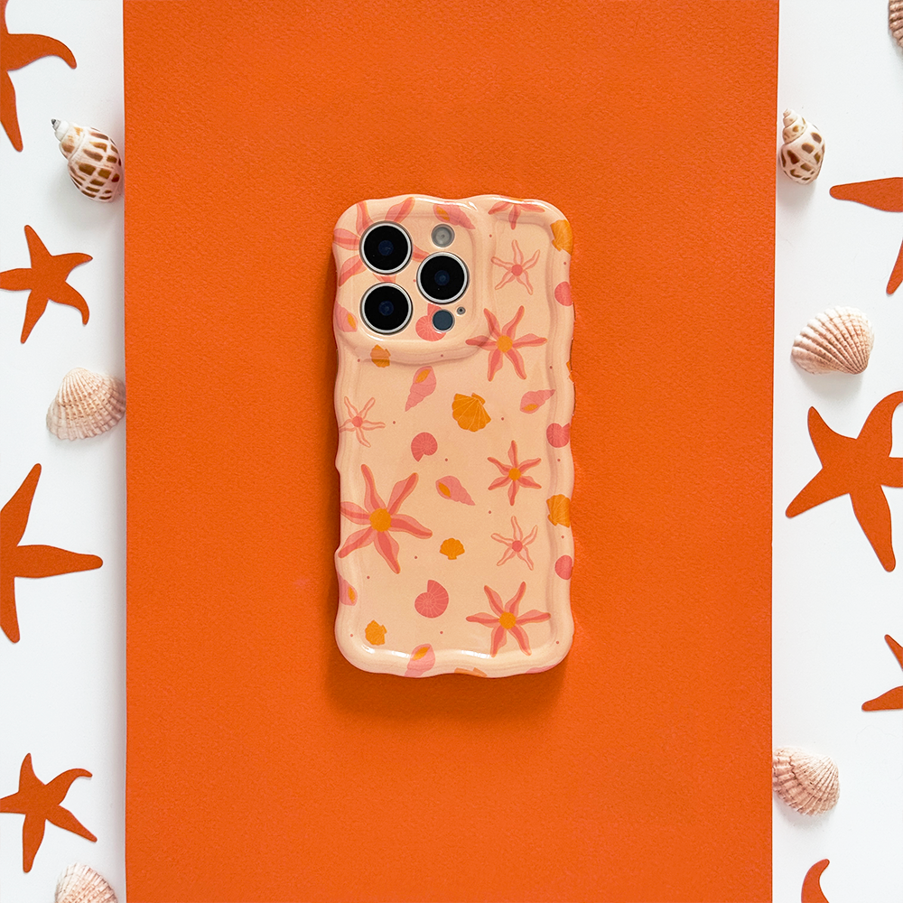 Orange wavy phone case with peach tones, decorated with seashell and starfish designs.