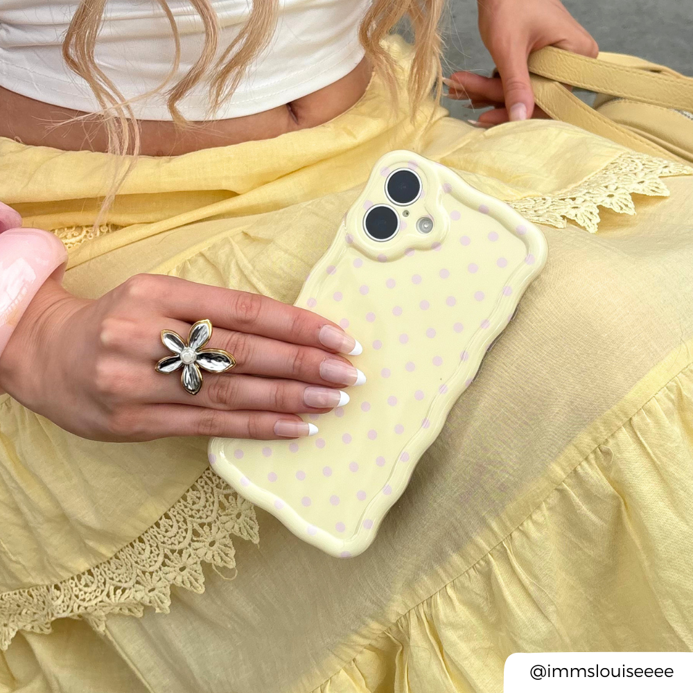 Wavy Phone Case Butter Blush being held by yellow flowy skirt
