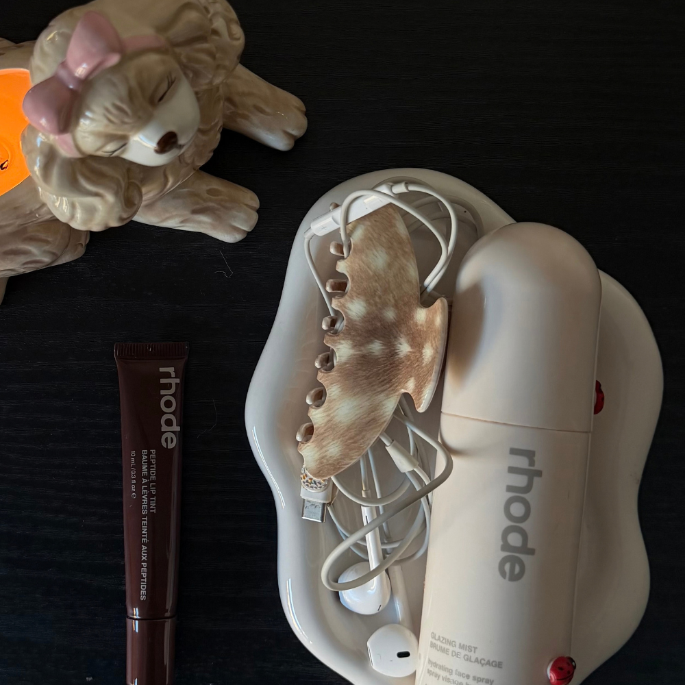 fawn clap clip on a table next to makeup products 