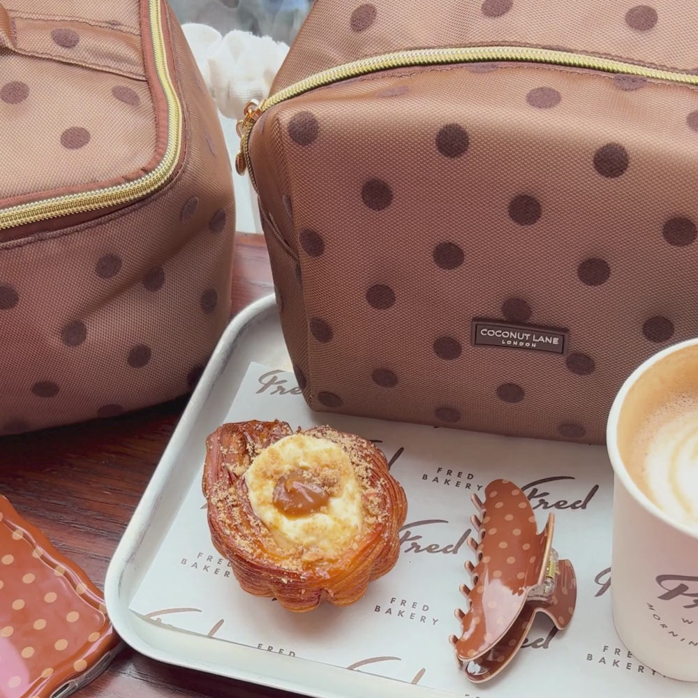 Dot Society Chocolate Brown claw clip, alongside the matching makeup bag, wavy phone case and vanity case.