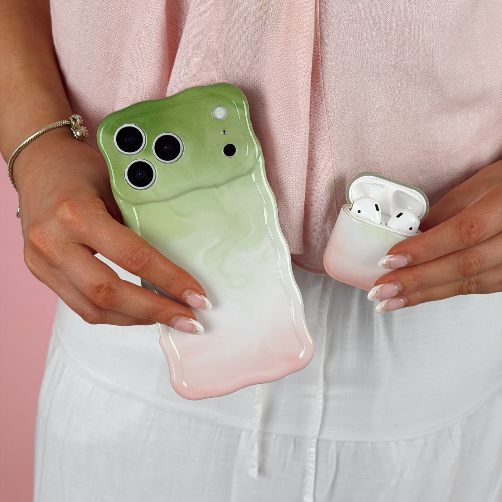 Girl holding airpods and wavy phone case in strawberry matcha design