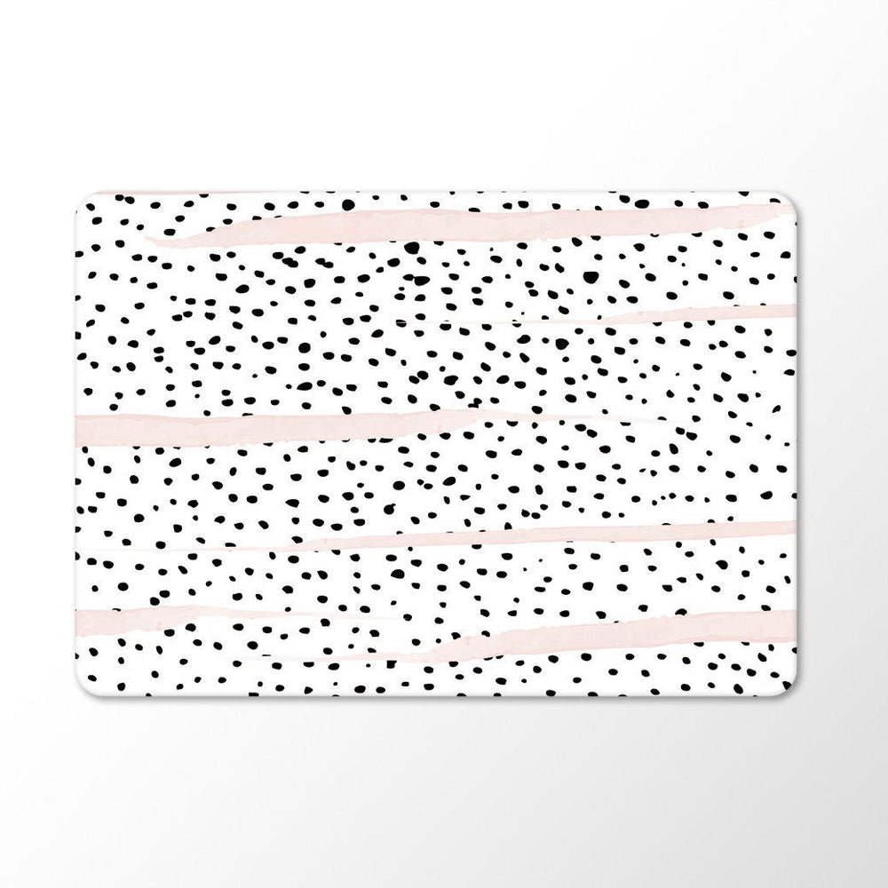 black and white dalmatian print with pink brush strokes on a macbook with white background